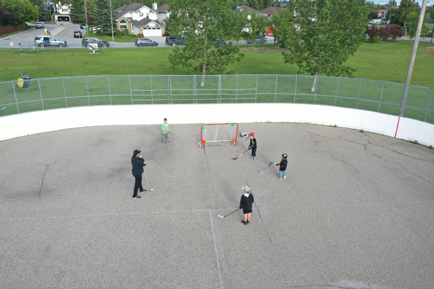 Players practicing ball hockey at the outdoor rink